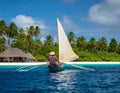 A traditional outrigger canoe sailing in Ailinglaplap Atoll, Royalty Free Stock Photo