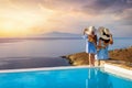 A beautiful mother and her daughter watching the summer sunset from a pool Royalty Free Stock Photo