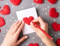 Hand of girl writing love letter on Valentine Day. Handmade red heart postcard. Woman write Royalty Free Stock Photo