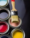 Paintbrush and Paint, Cans of Primary Colored Paints on Black Ba. Royalty Free Stock Photo