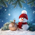 Festive Christmas card with snowman, Christmas bauble and fir branches on winter background Royalty Free Stock Photo