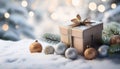 Christmas winter background with gift box, Christmas baubles and fir tree branches on snow. Royalty Free Stock Photo