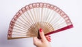 Womans manicured hand with fan against white background Royalty Free Stock Photo