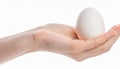 Female teen hand holding egg, isolated on white Royalty Free Stock Photo