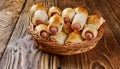 Pigs in a planket. Puff pastry rolls with sausages on a wooden background. Fast food or beer Royalty Free Stock Photo