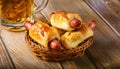 Pigs in a planket. Puff pastry rolls with sausages on a wooden background. Fast food or beer Royalty Free Stock Photo