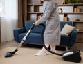 Floor cleaning. Woman cleaning the floor with vacuum cleaner Royalty Free Stock Photo