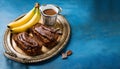 Chocolate banana date dread on a vintage tray on a blue stone background. Copy space. Royalty Free Stock Photo
