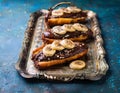 Chocolate banana date dread on a vintage tray on a blue stone background. Copy space. Royalty Free Stock Photo