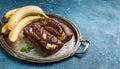 Chocolate banana date dread on a vintage tray on a blue stone background. Copy space. Royalty Free Stock Photo