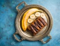 Chocolate banana date dread on a vintage tray on a blue stone background. Copy space. Royalty Free Stock Photo