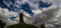 Bruges, Belgium, walking path alongside the ramparts : Sint-Janshuis windmill with fluffy clouds. Royalty Free Stock Photo