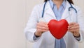 Doctor holding heart. Female doctor with the stethoscope holding heart Royalty Free Stock Photo