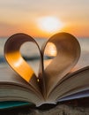 Heart shape paper book on the beach. Heart from a book page on the beach against a beautiful Royalty Free Stock Photo