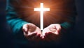 Person palm hands to hold holy cross, crucifix to worship. Royalty Free Stock Photo