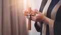 Person palm hands to hold holy cross, crucifix to worship. Royalty Free Stock Photo