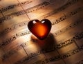 Love Music. Light heart on vintage music sheet Royalty Free Stock Photo