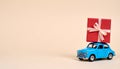 Car with staple gift on neutral background Royalty Free Stock Photo