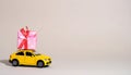 Car with staple gift on neutral background Royalty Free Stock Photo