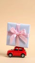 Car with staple gift on neutral background Royalty Free Stock Photo