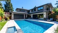 New modern house with backyard swimming pool on sunny day Royalty Free Stock Photo