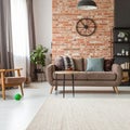 Beige carpet in modern living room interior with industrial furniture and brick wall Royalty Free Stock Photo