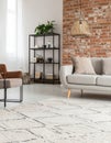Beige carpet in modern living room interior with industrial furniture and brick wall Royalty Free Stock Photo