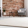 Beige carpet in modern living room interior with industrial furniture and brick wall Royalty Free Stock Photo
