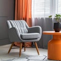 Grey armchair at orange table in dark retro living room interior with drapes Royalty Free Stock Photo