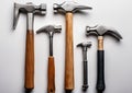 Various hammers are organized vertically on a light surface Royalty Free Stock Photo
