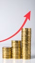 Stack of gold coins with arrow reaching higher Royalty Free Stock Photo