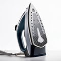 A modern electric steam iron with a sleek design, shown standing vertically on a reflective surface Royalty Free Stock Photo
