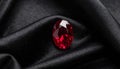Faceted Ruby Sparkling on Velvet-Textured Black Background Royalty Free Stock Photo