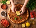 Traditional delicious Turkish foods Turkish Lahmacun. top view. The woman squeezes Royalty Free Stock Photo