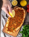 Traditional delicious Turkish foods Turkish Lahmacun. top view. The woman squeezes Royalty Free Stock Photo