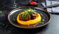 Tender braised beef cheeks served atop smooth pumpkin puree, garnished with microgree Royalty Free Stock Photo
