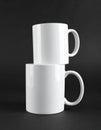 Two blank white mugs on black background. Mockup for design Royalty Free Stock Photo