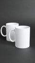 Two blank white mugs on black background. Mockup for design Royalty Free Stock Photo
