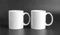Two blank white mugs on black background. Mockup for design Royalty Free Stock Photo