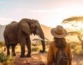 A female tourist watches a large elephant Royalty Free Stock Photo
