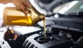 Man pouring motor oil into car engine, closeup Royalty Free Stock Photo