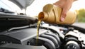 Man pouring motor oil into car engine, closeup Royalty Free Stock Photo