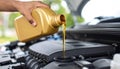 Man pouring motor oil into car engine, closeup Royalty Free Stock Photo