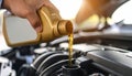 Man pouring motor oil into car engine, closeup Royalty Free Stock Photo
