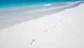 Footprints on a Bright Beach with Emerald Water Royalty Free Stock Photo
