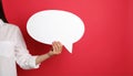 Woman holding blank speech bubble on red background, closeup. Space for text Royalty Free Stock Photo