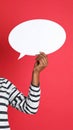 Woman holding blank speech bubble on red background, closeup. Space for text Royalty Free Stock Photo