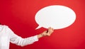 Woman holding blank speech bubble on red background, closeup. Space for text Royalty Free Stock Photo