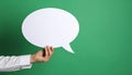 Woman holding blank speech bubble on green background, closeup. Space for text Royalty Free Stock Photo