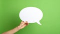 Woman holding blank speech bubble on green background, closeup. Space for text Royalty Free Stock Photo